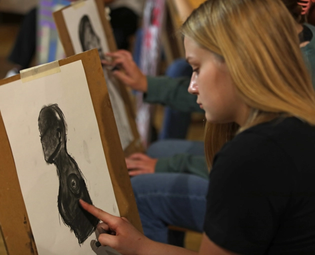 Student drawing a portrait